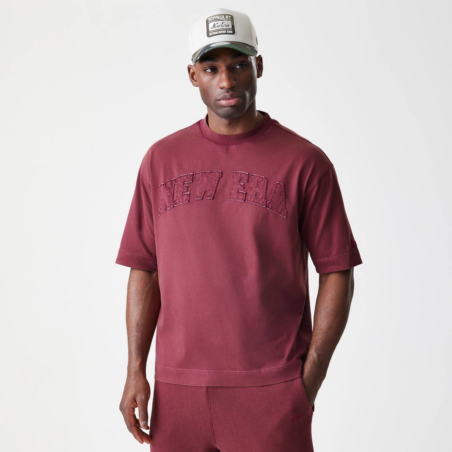 The Male model is wearing  New Era Washed Dark Red Oversized T-Shirt 3