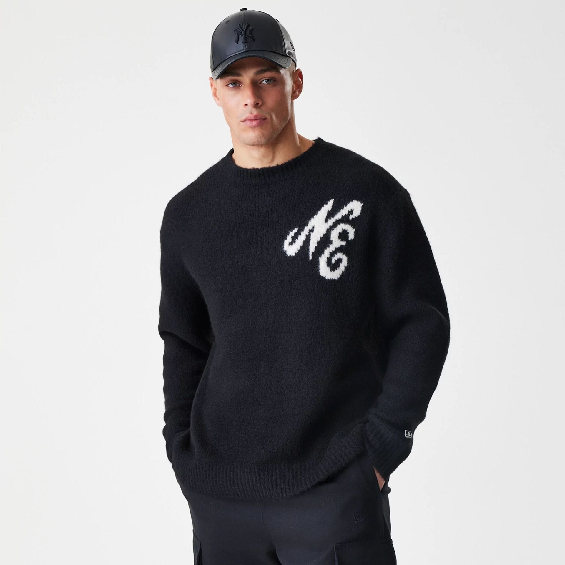 The Male model is wearing New Era Knit Black Knitted Sweater 3