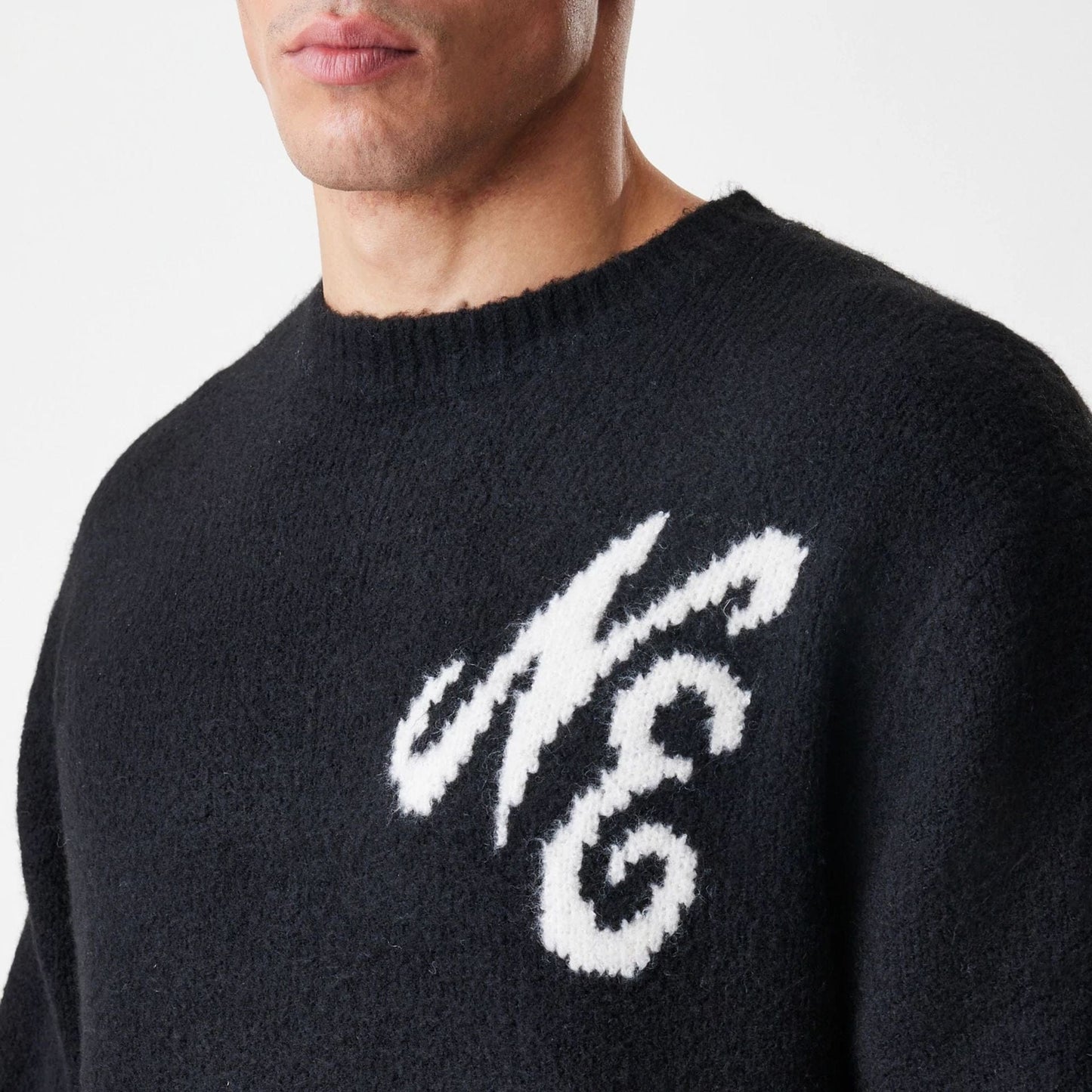 The Male model is wearing New Era Knit Black Knitted Sweater 5