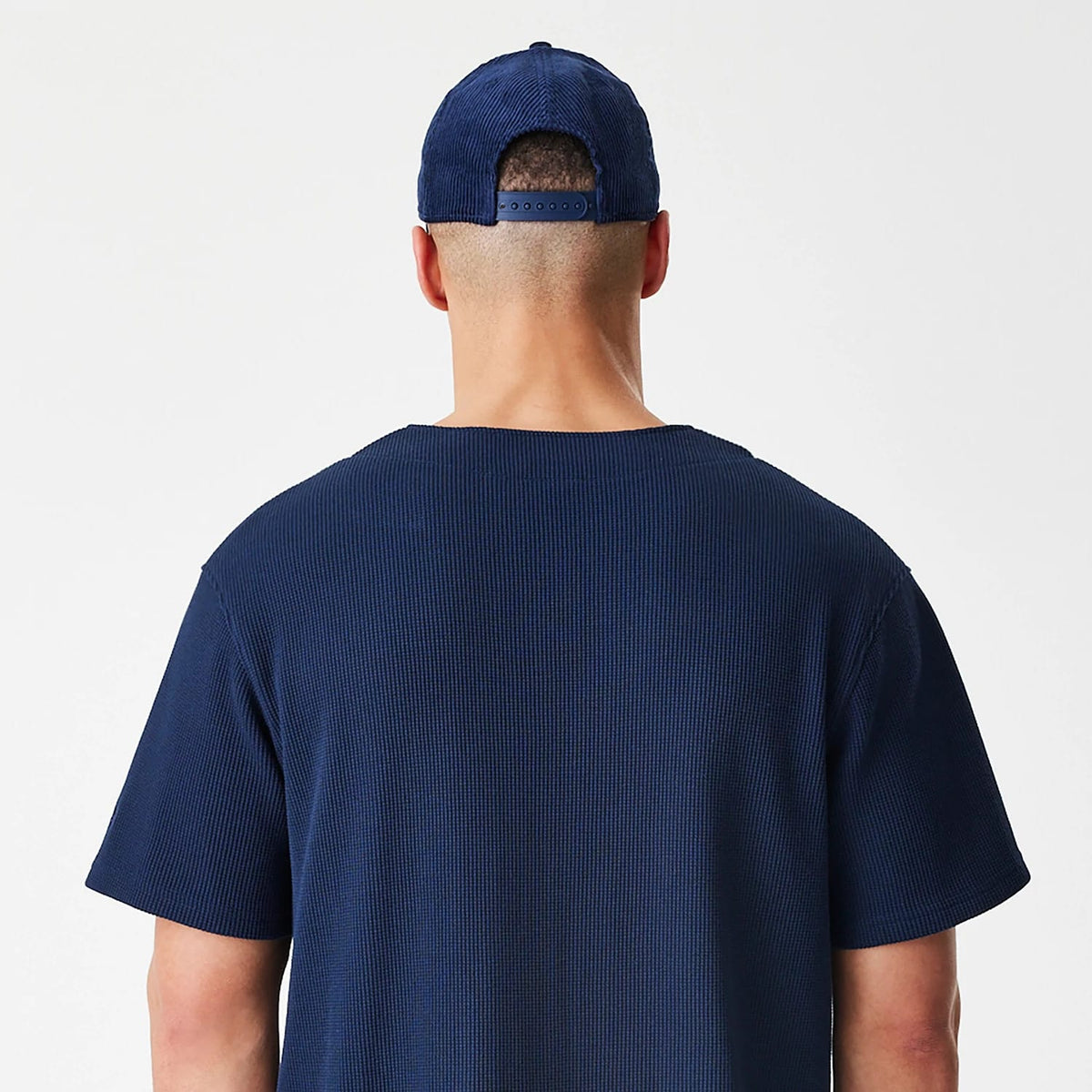 The Male model is wearing  New Era Waffle Navy Jersey 8