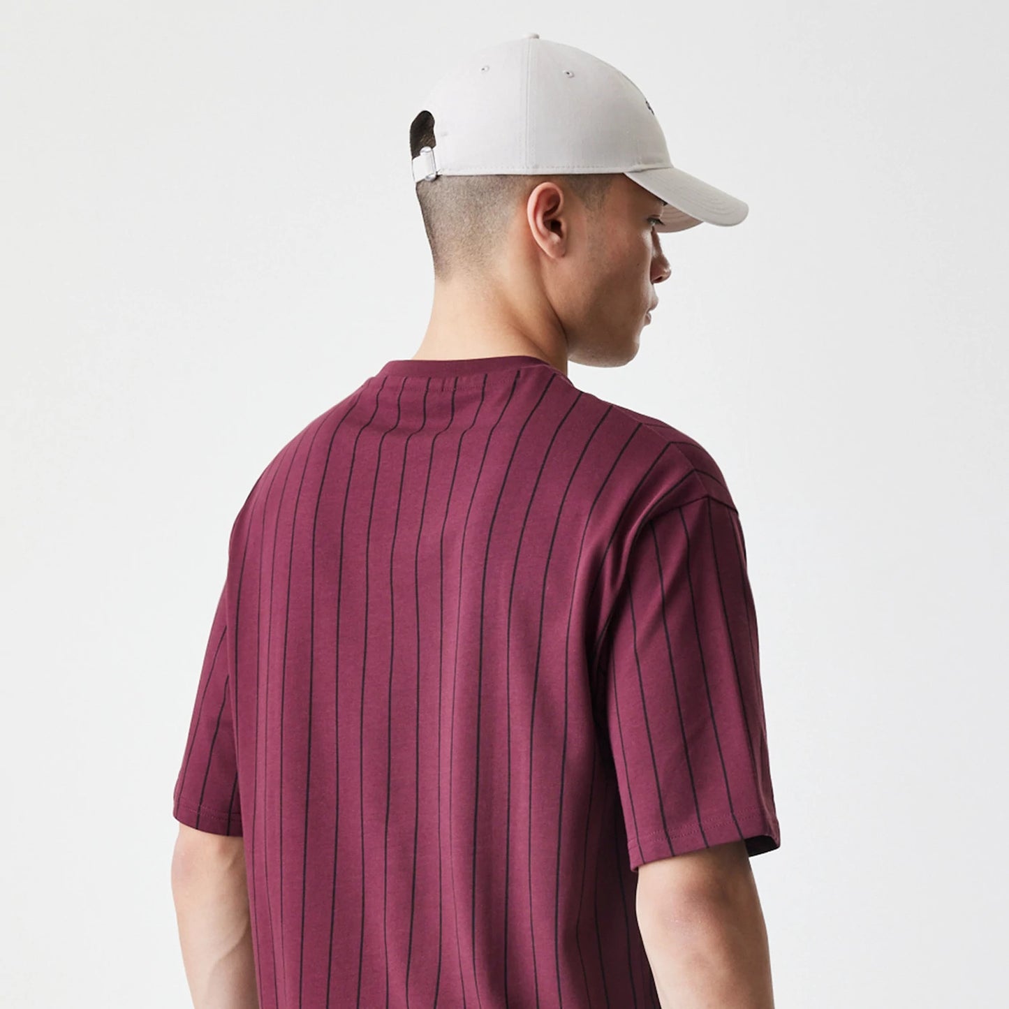 The Male model is wearing  New Era Pinstripe Dark Red Oversized T-Shirt 7