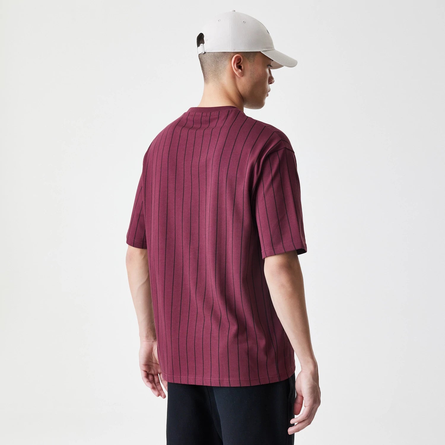 The Male model is wearing  New Era Pinstripe Dark Red Oversized T-Shirt 2