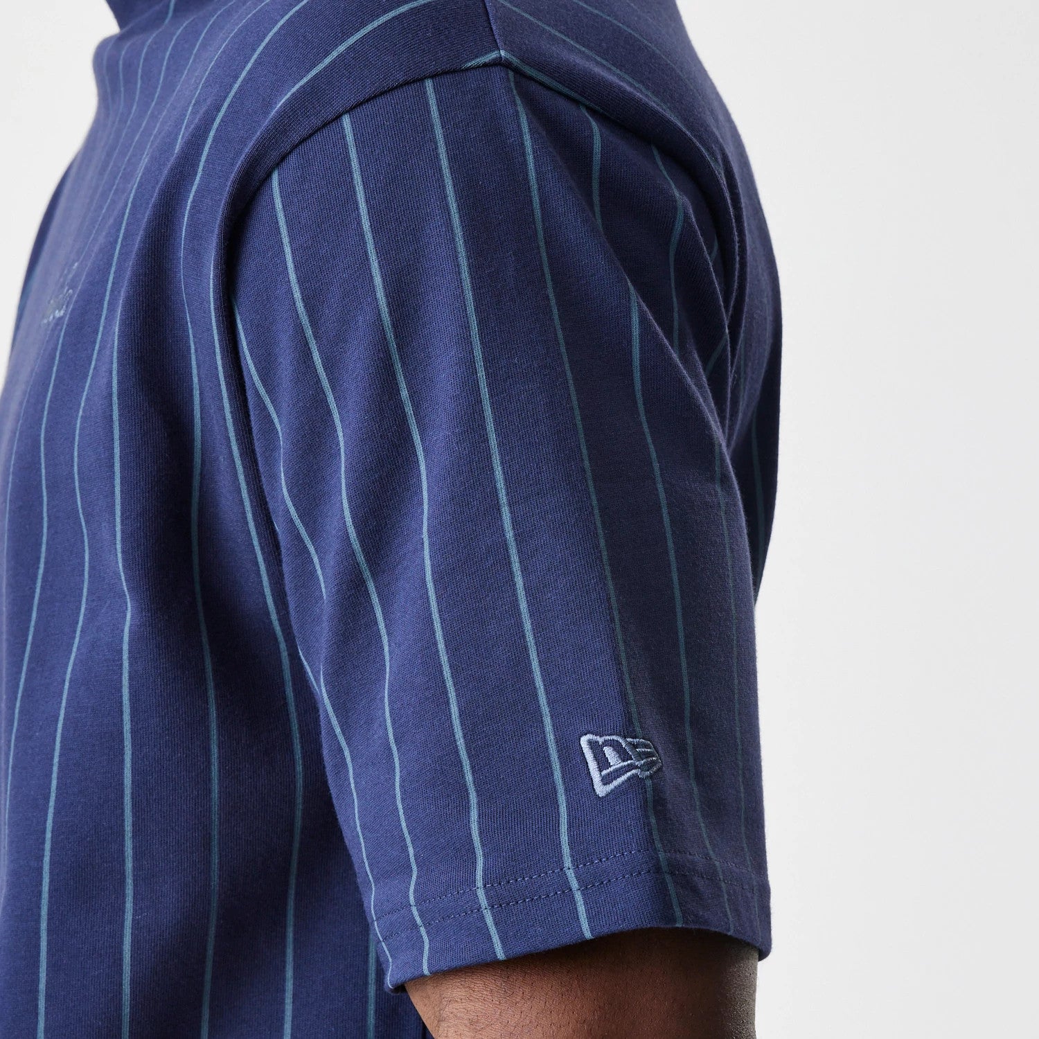 The Male model is wearing  New Era Pinstripe Navy Oversized T-Shirt 5