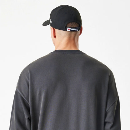 The Male model is wearing Las Vegas Raiders NFL Washed Boxy Dark Grey Oversized Crew Neck Sweater  8