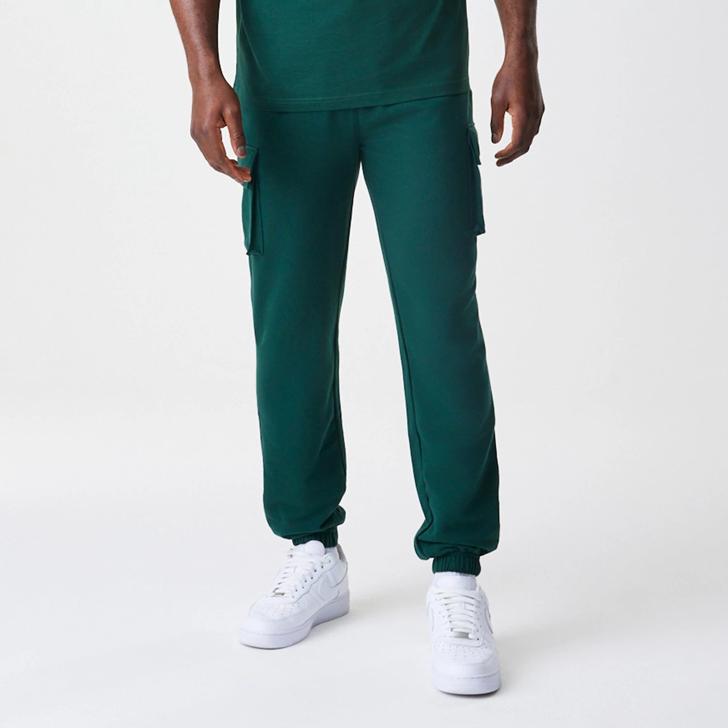 The Male model is wearing  New Era Core Cargo Dark Green Joggers 3