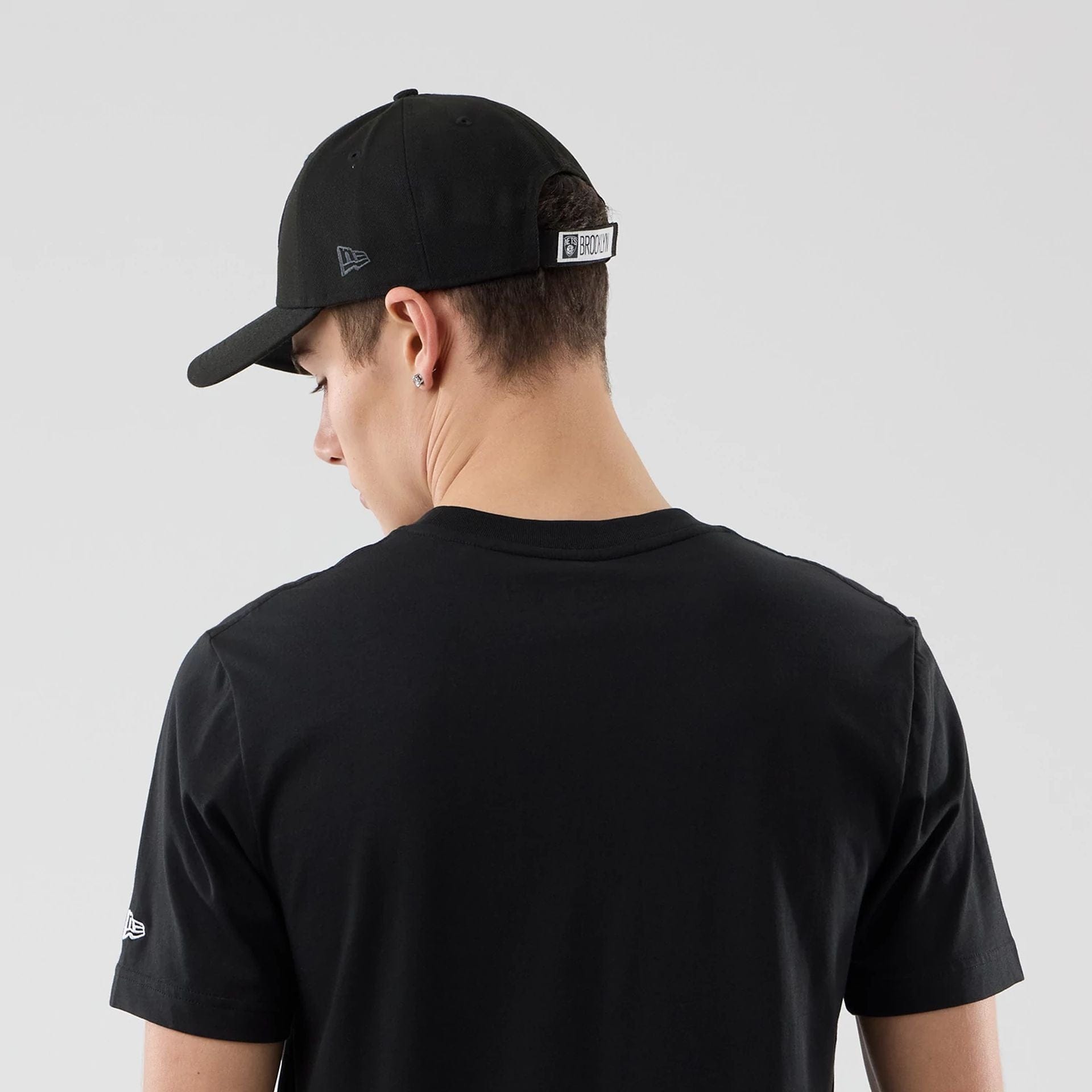 The Male model is wearing Brooklyn Nets NBA City Edition Black T-Shirt  7