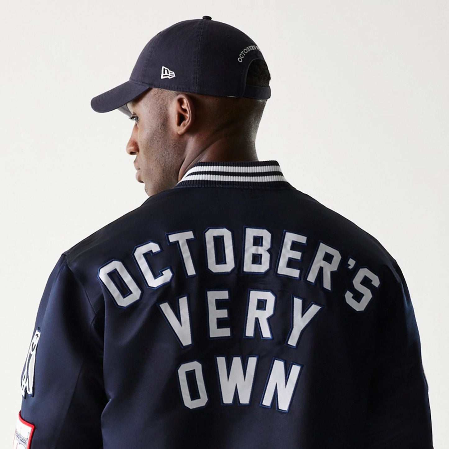The Male model is wearing New York Yankees OVO x MLB Navy Jacket 7