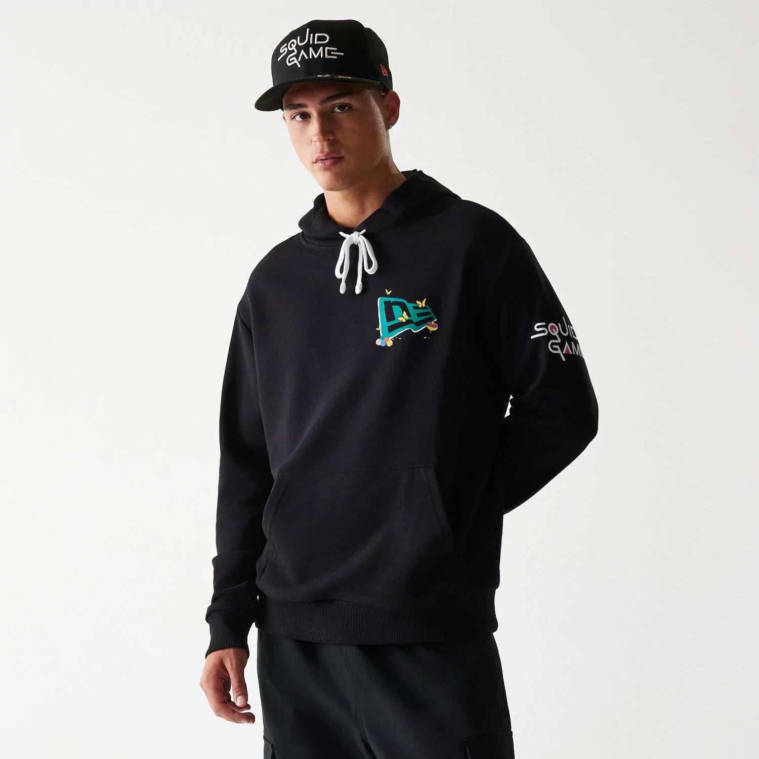 The Male model is wearing Netflix Squid Game Black Oversized Pullover Hoodie 1