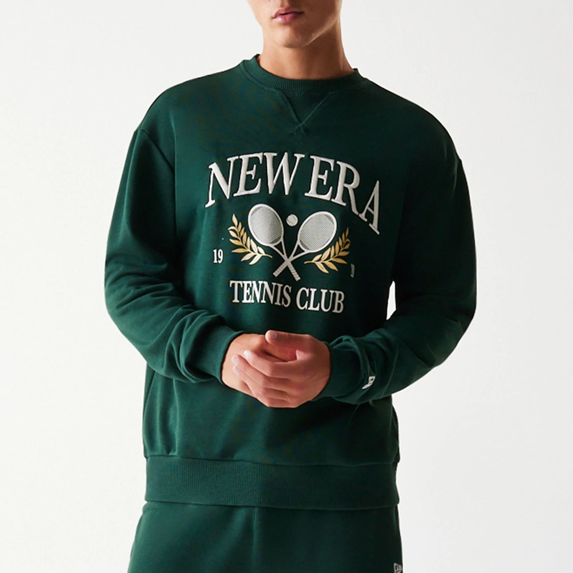 The Male model is wearing New Era Dark Green Oversized Crew Neck Sweater 3