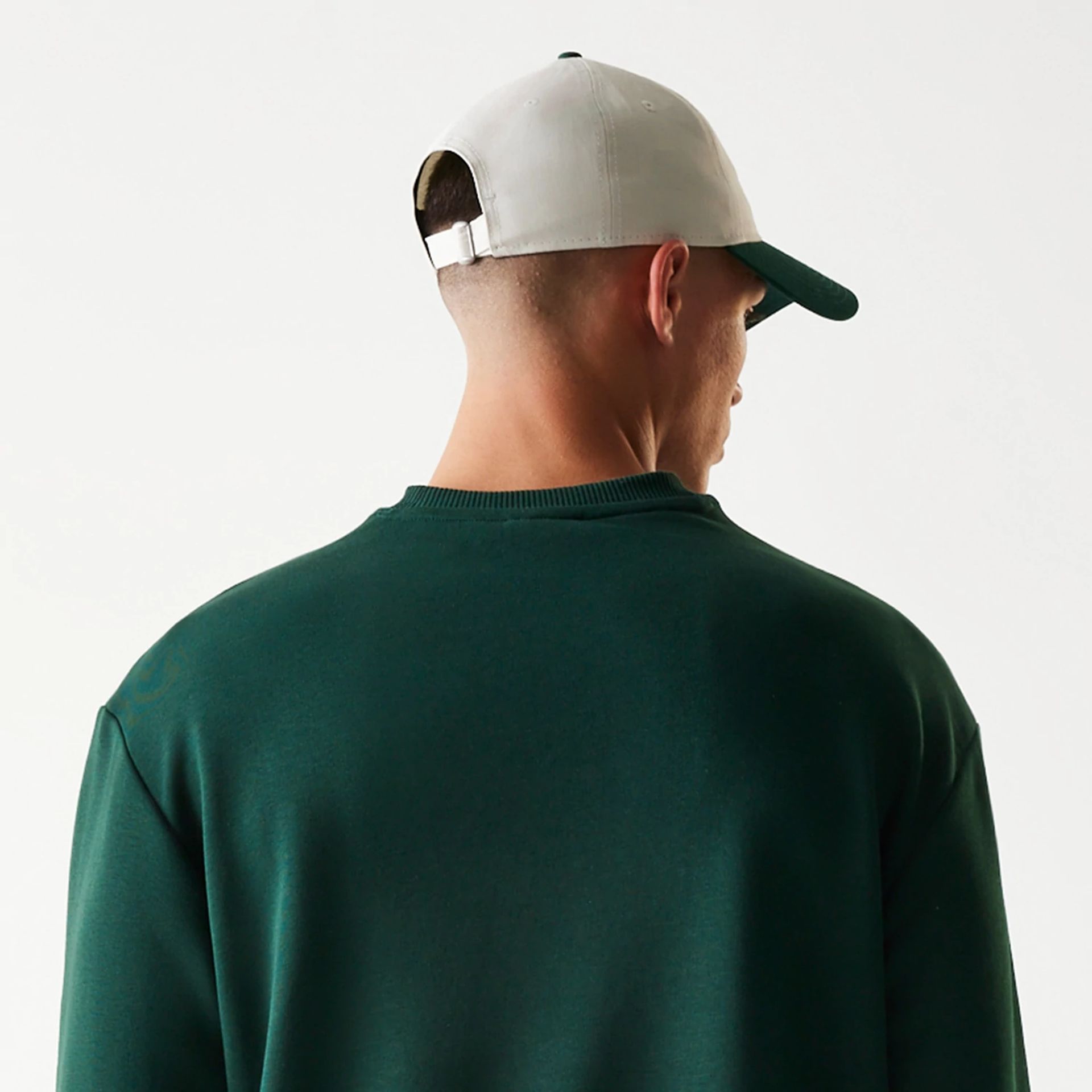 The Male model is wearing New Era Dark Green Oversized Crew Neck Sweater 7