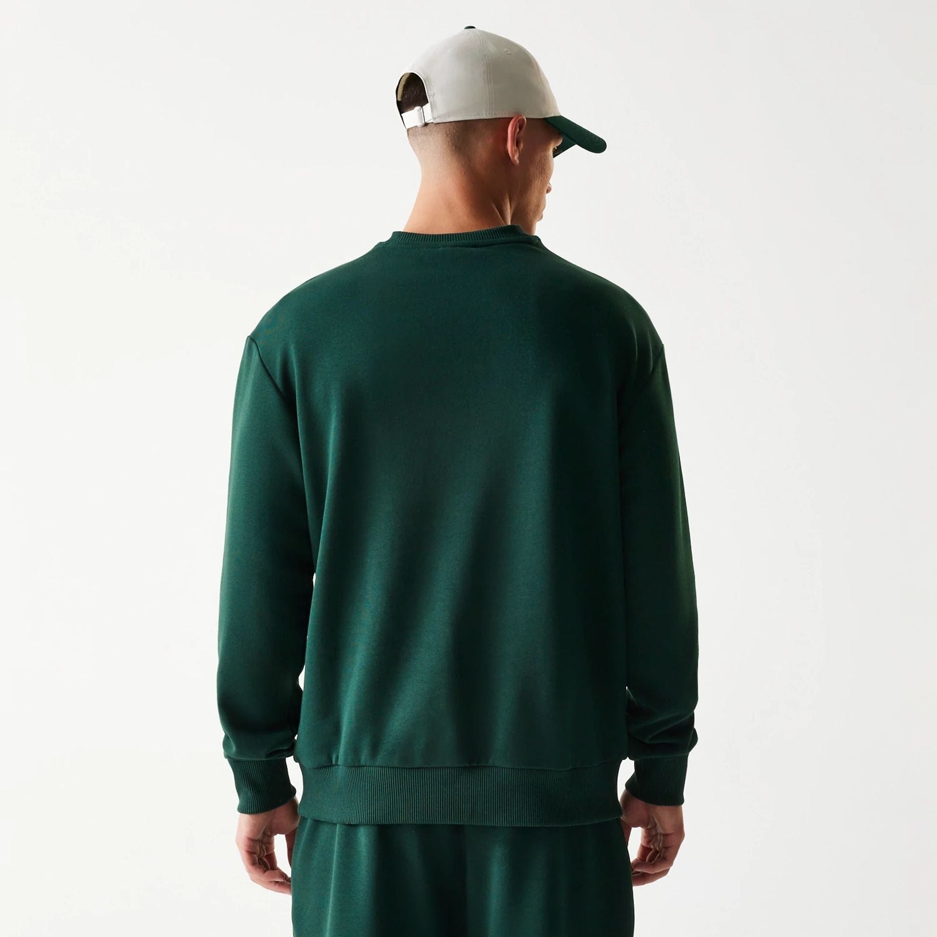The Male model is wearing New Era Dark Green Oversized Crew Neck Sweater 2