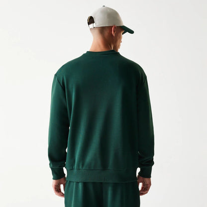 The Male model is wearing New Era Dark Green Oversized Crew Neck Sweater 2