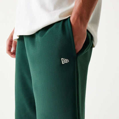 The Male model is wearing New Era Front Logo Dark Green Shorts 6