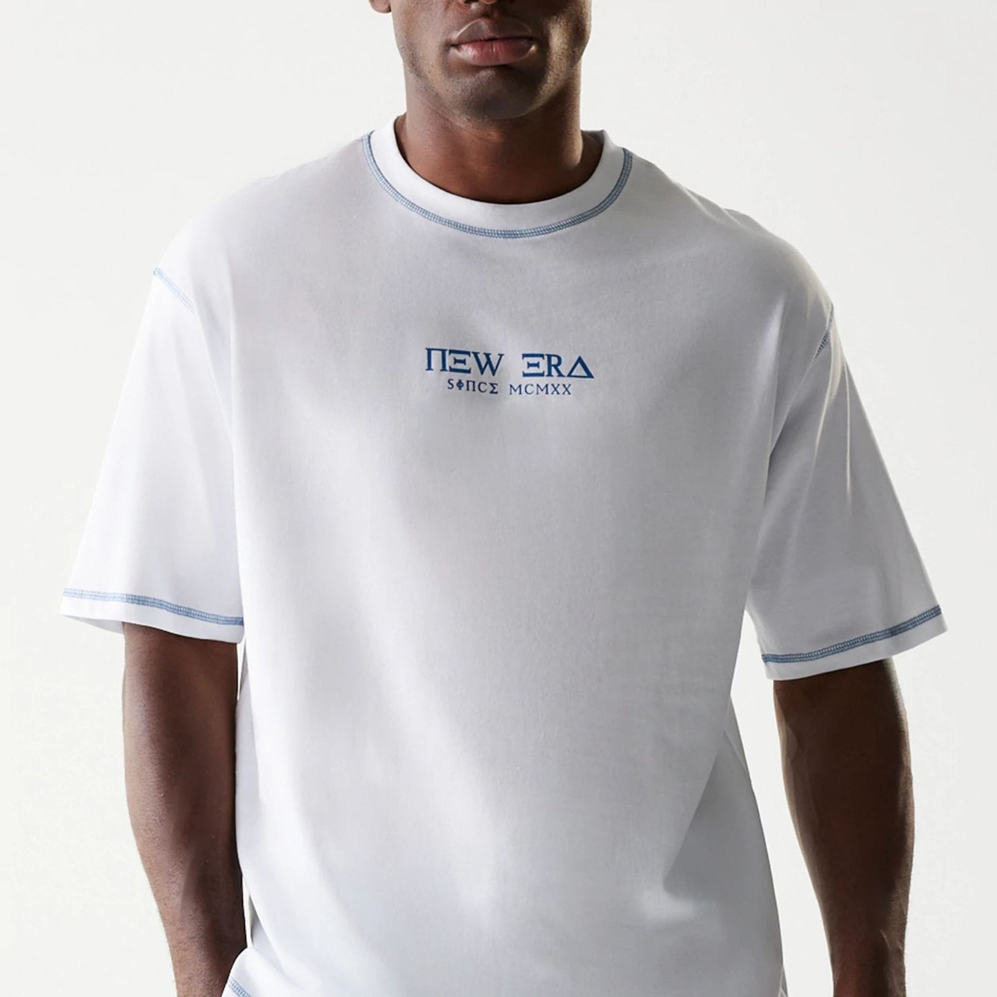The Male model is wearing New Era Orthodox Church White Oversized T-Shirt 4