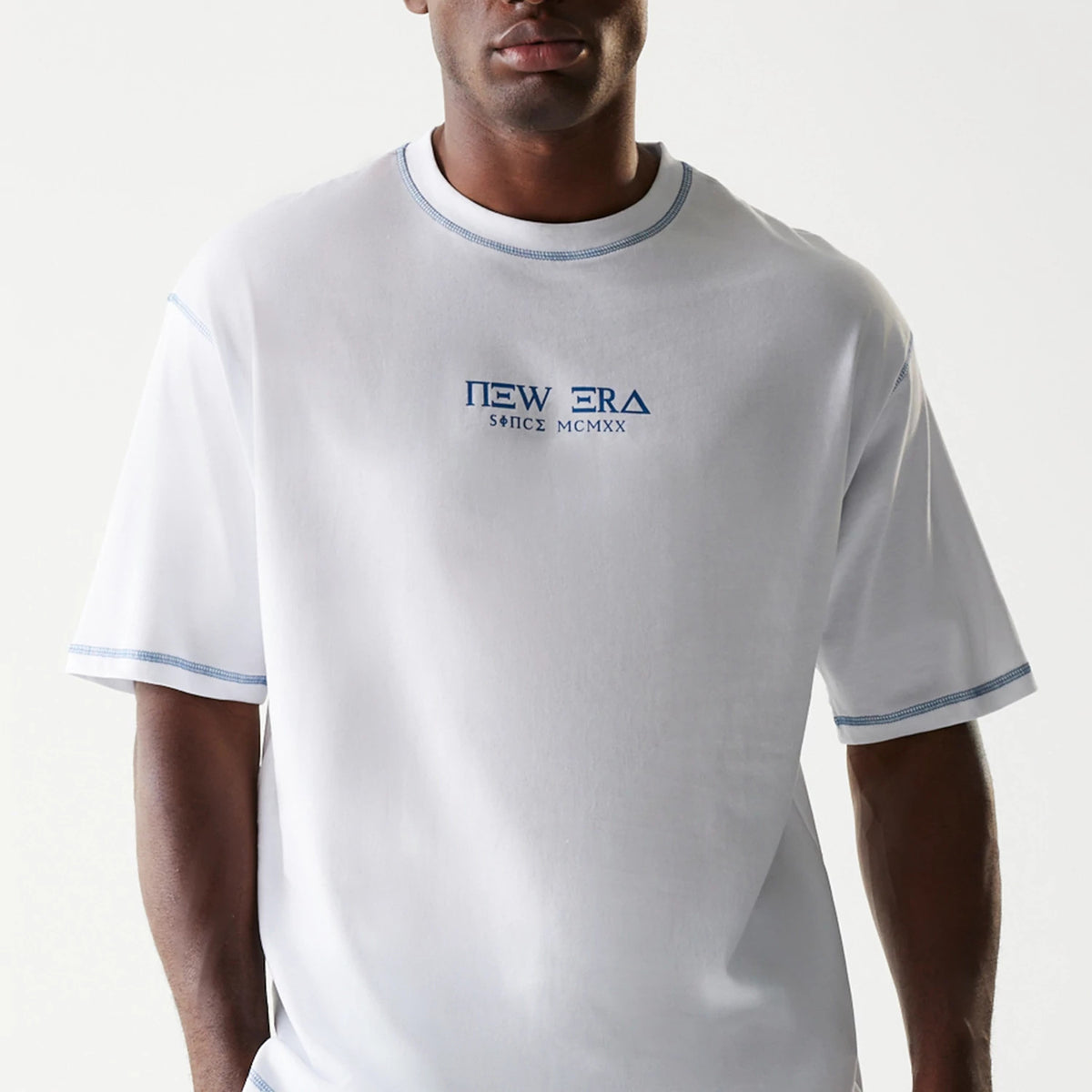 The Male model is wearing New Era Orthodox Church White Oversized T-Shirt 4