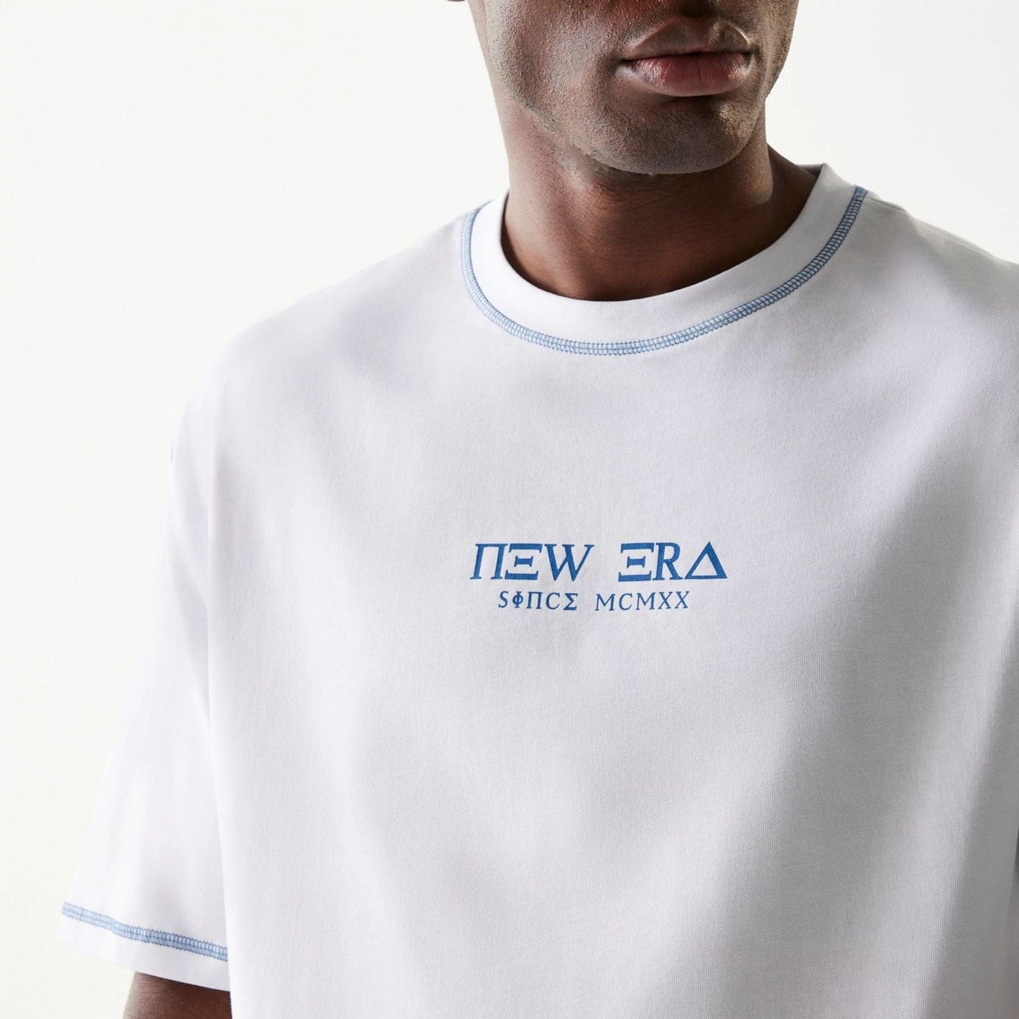 The Male model is wearing New Era Orthodox Church White Oversized T-Shirt 3