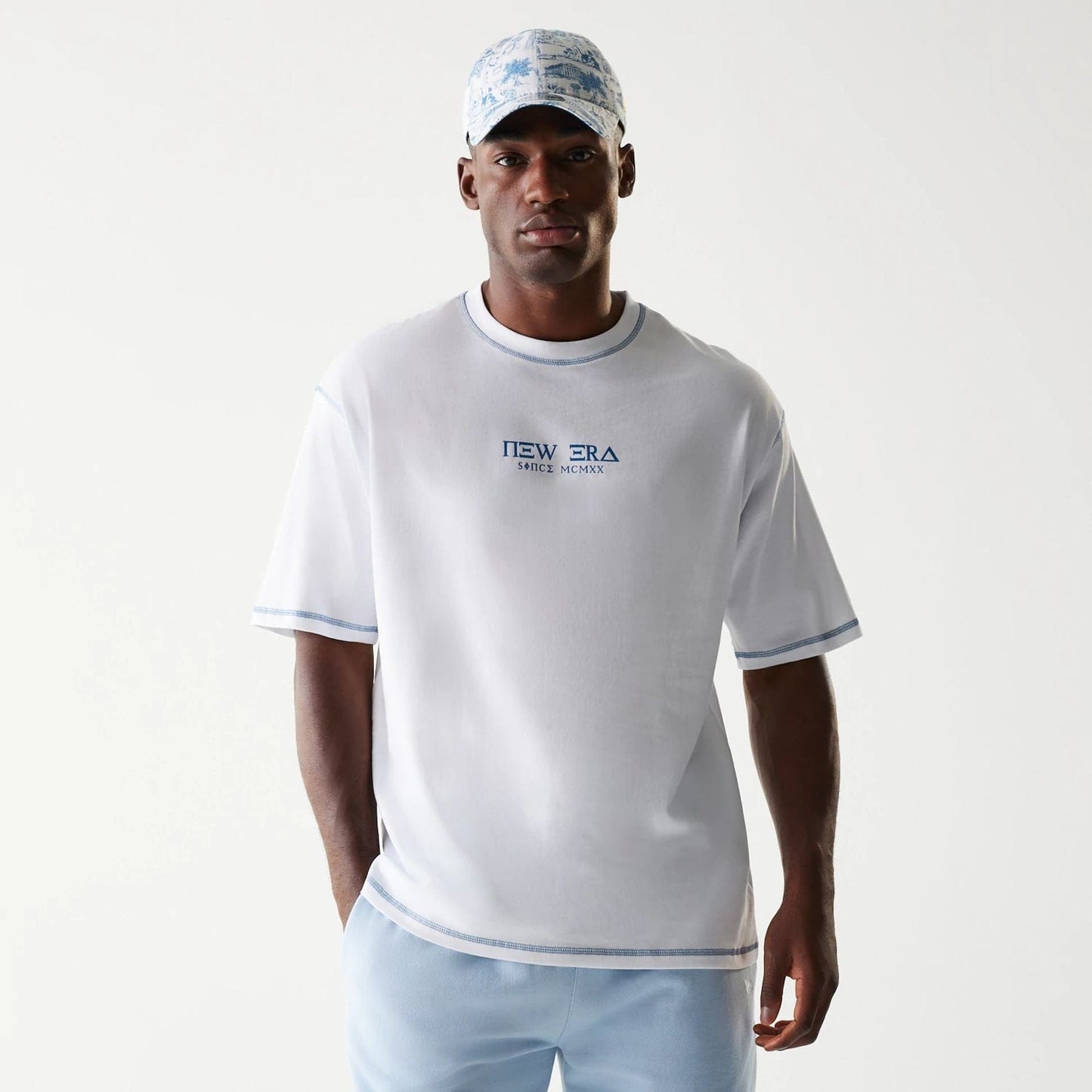 The Male model is wearing New Era Orthodox Church White Oversized T-Shirt 1