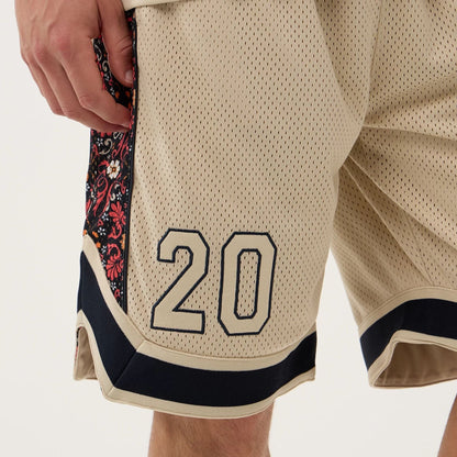 The Male model is wearing New Era Mesh Light Beige Mesh Shorts 3
