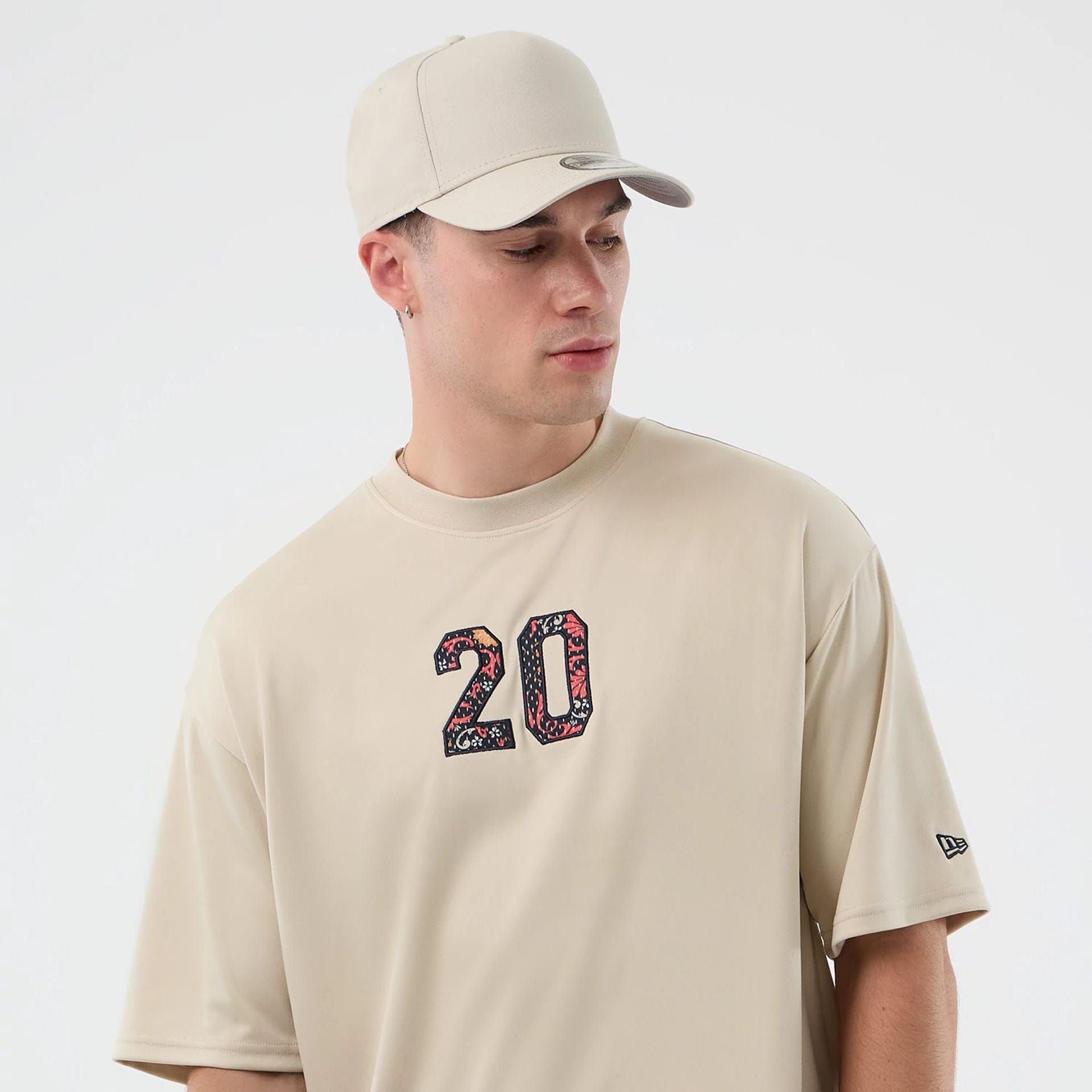 The Male model is wearing New Era Mesh Infill Light Beige Oversized T-Shirt 6