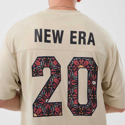 The Male model is wearing New Era Mesh Infill Light Beige Oversized T-Shirt 7