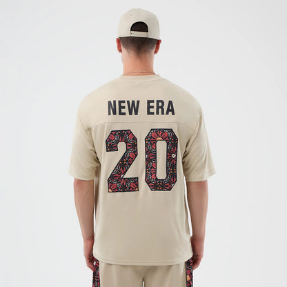 New Era Mesh Infill Light Beige Oversized T-Shirt, back view showing a black New Era text above the number 20 filled with floral patterns in red and black, creating an eye-catching contrast on light beige fabric.