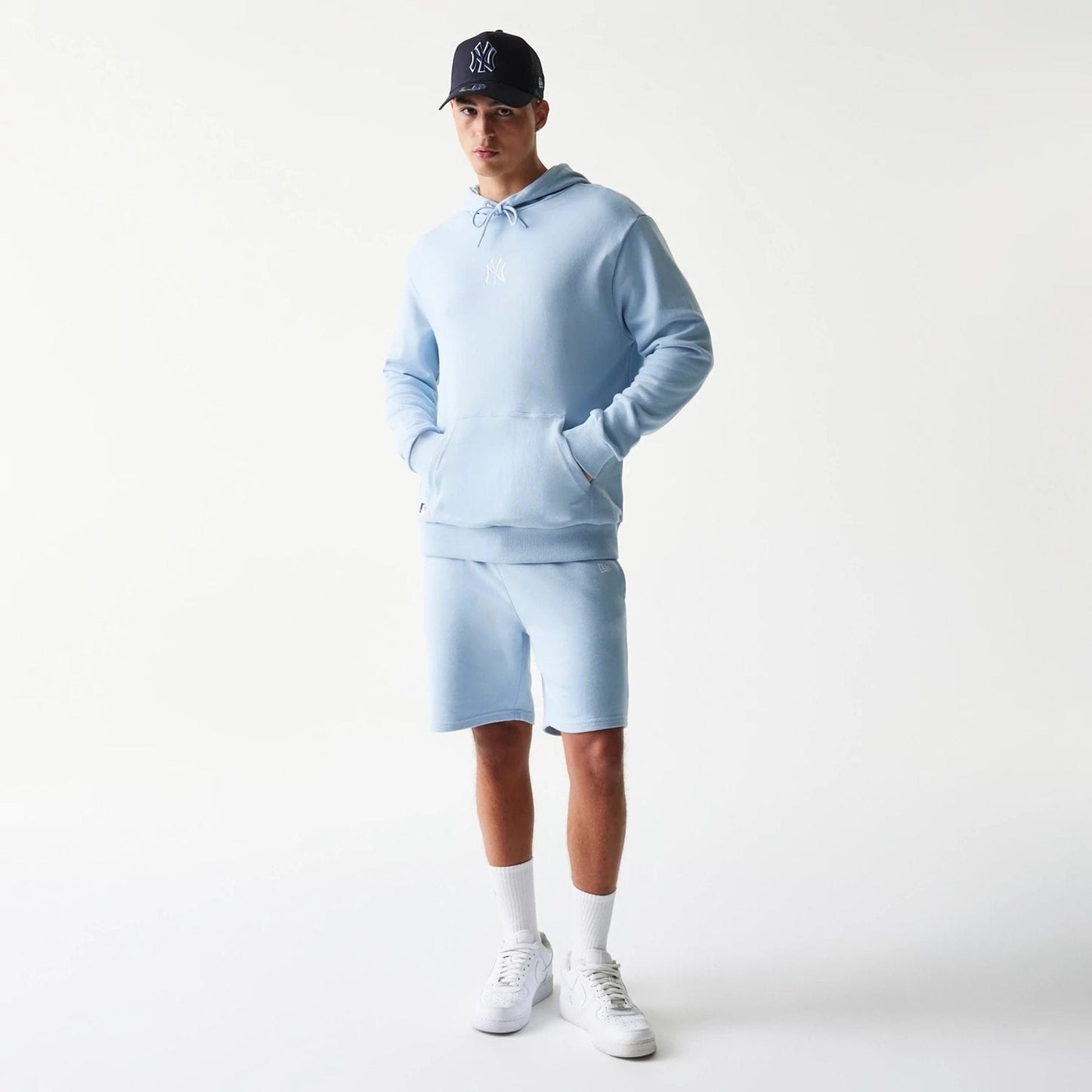 The model is wearing this MLB League Essential Midi New York Yankees Oversized Pullover Hoodie in pastel blue. 8