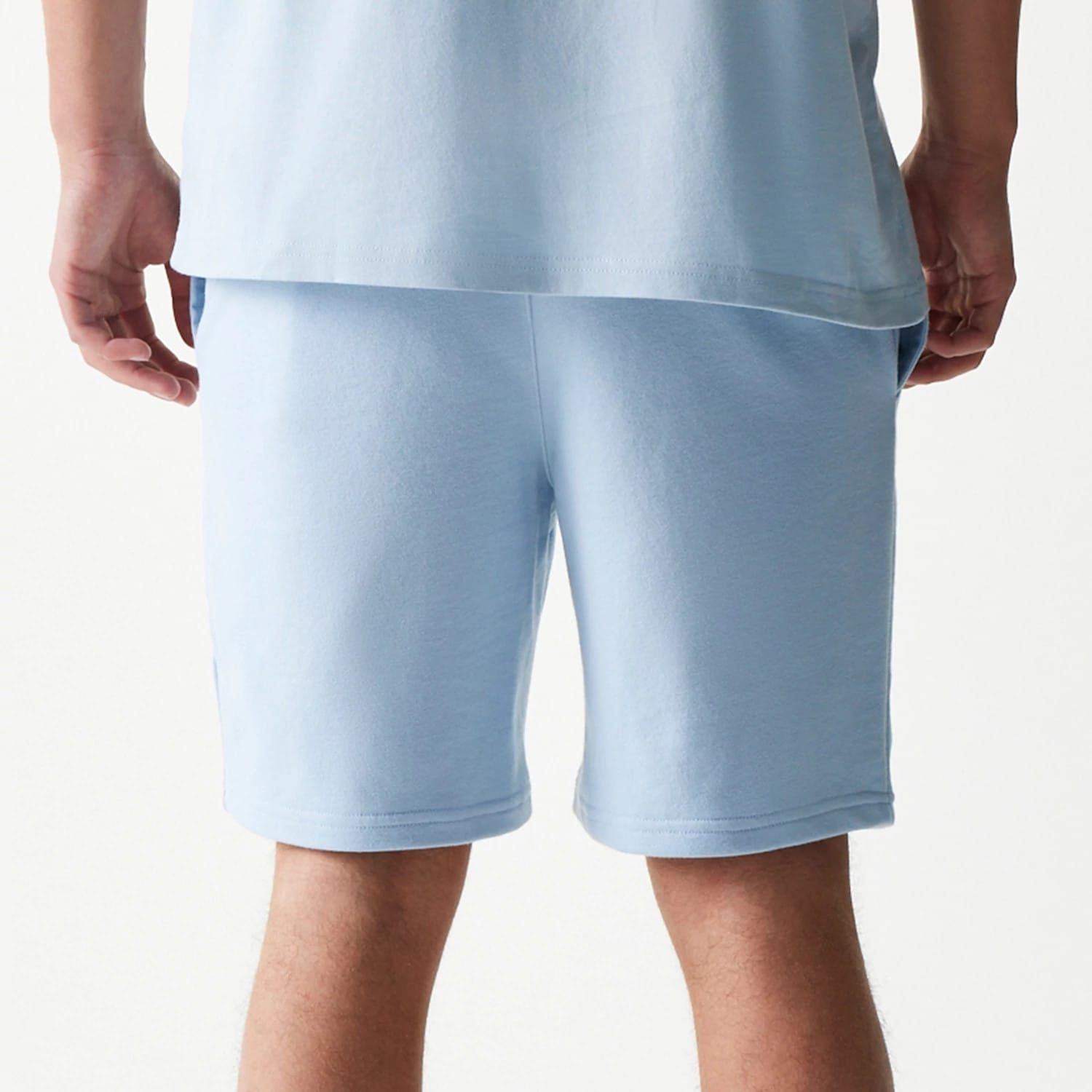 The model is wearing this MLB League Essential Midi New York Yankees Shorts in pastel blue. 7