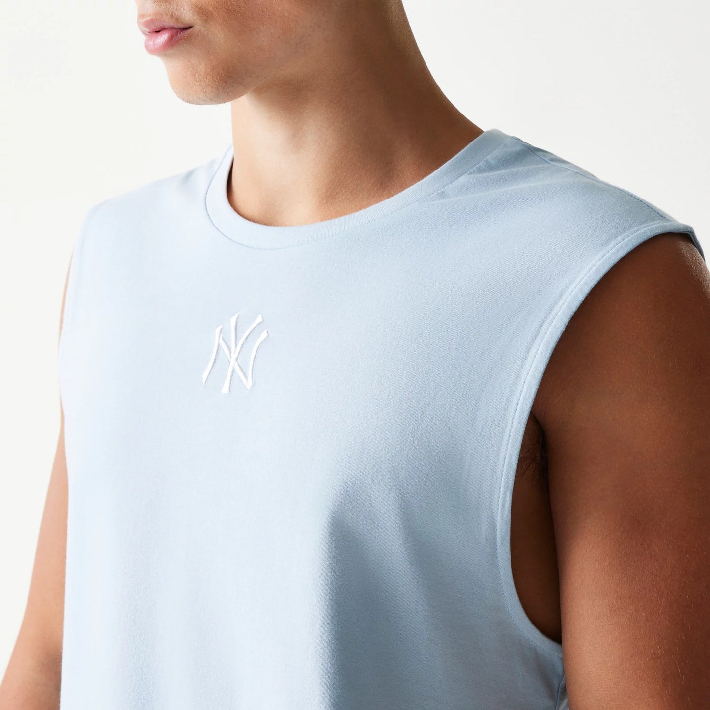 The model is wearing this MLB League Essential New York Yankees Sleeveless T-Shirt in pastel blue. 3