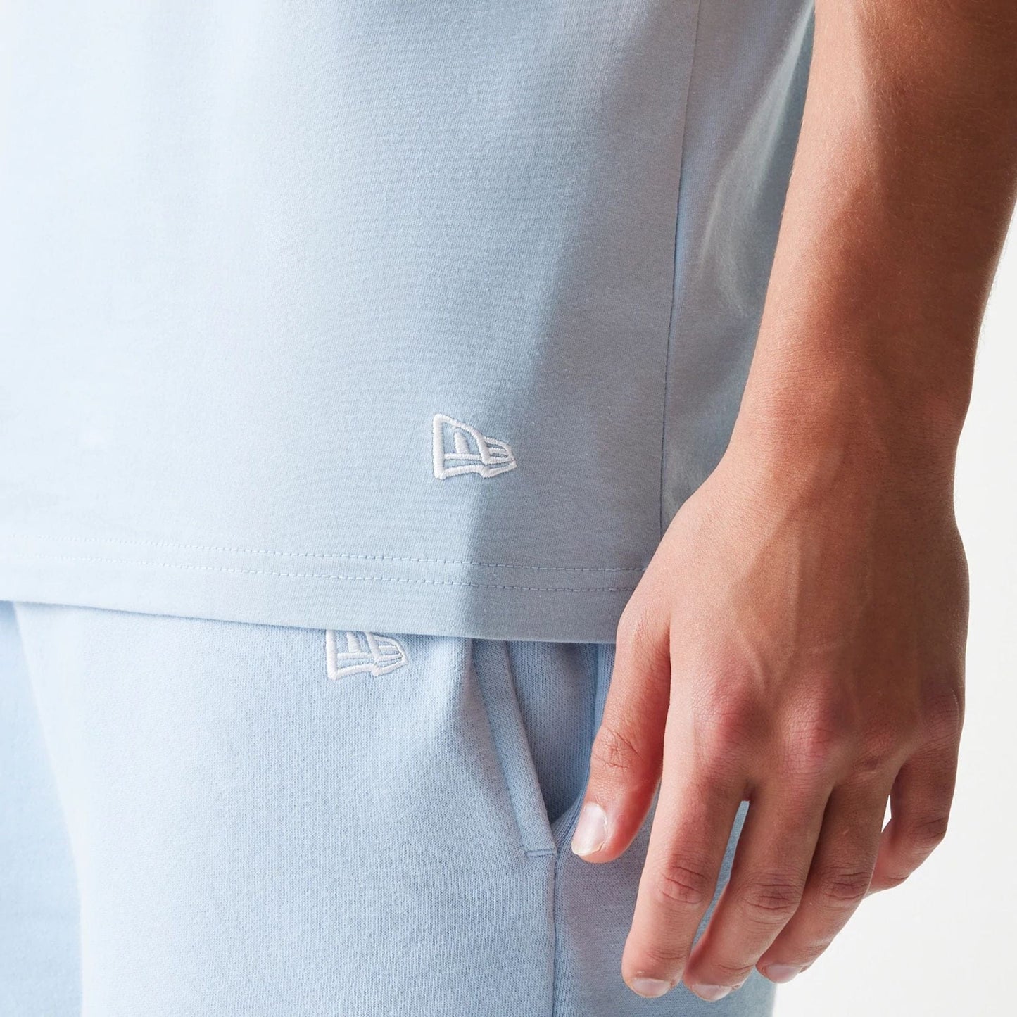 The model is wearing this MLB League Essential New York Yankees Sleeveless T-Shirt in pastel blue. 5