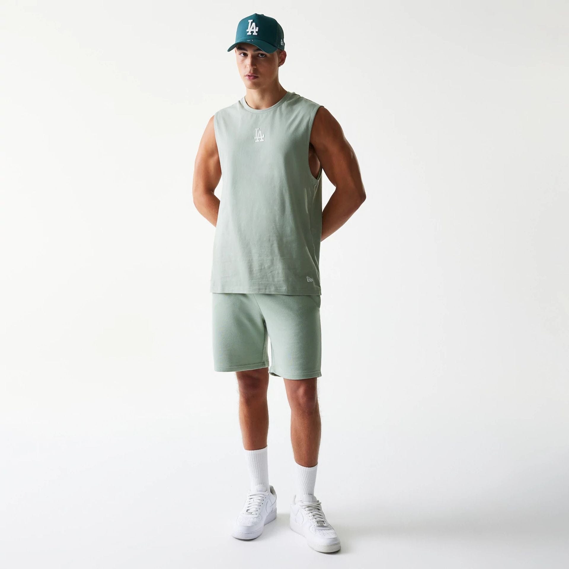 The model is wearing this MLB League Essential LA Dodgers Sleeveless T-Shirt in pastel green. 3