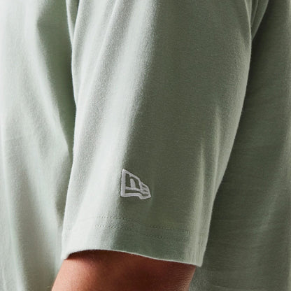 The model is wearing this MLB League Essential Midi LA Dodgers Oversized T-Shirt in pastel green. 7