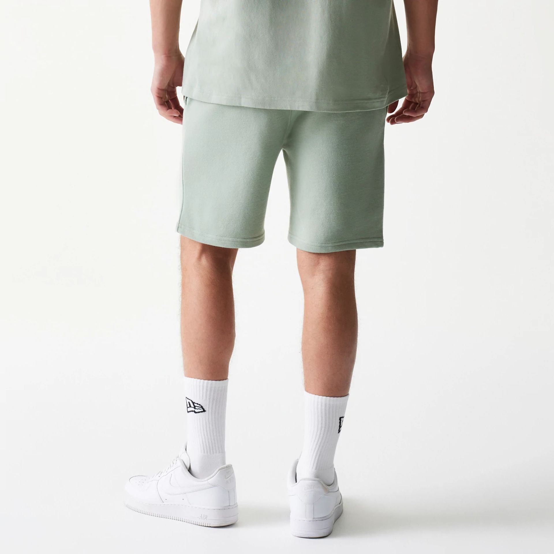 The model is wearing this MLB League Essential Midi LA Dodgers Shorts in pastel green. 2