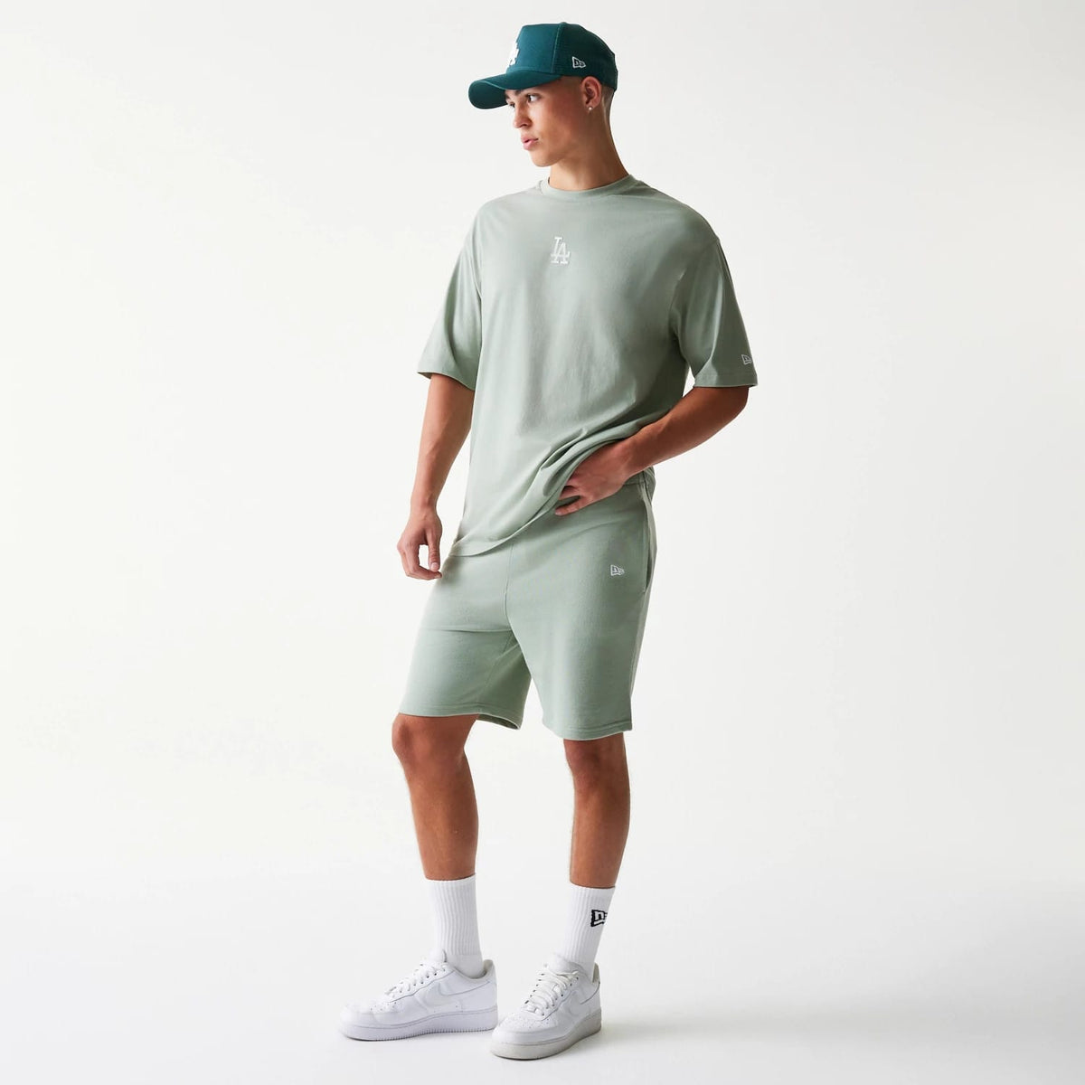 The model is wearing this MLB League Essential Midi LA Dodgers Shorts in pastel green. 8
