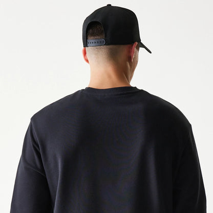 The model is wearing this NBA League Essential Chicago Bulls Oversized Crew Neck Sweater in black. 7