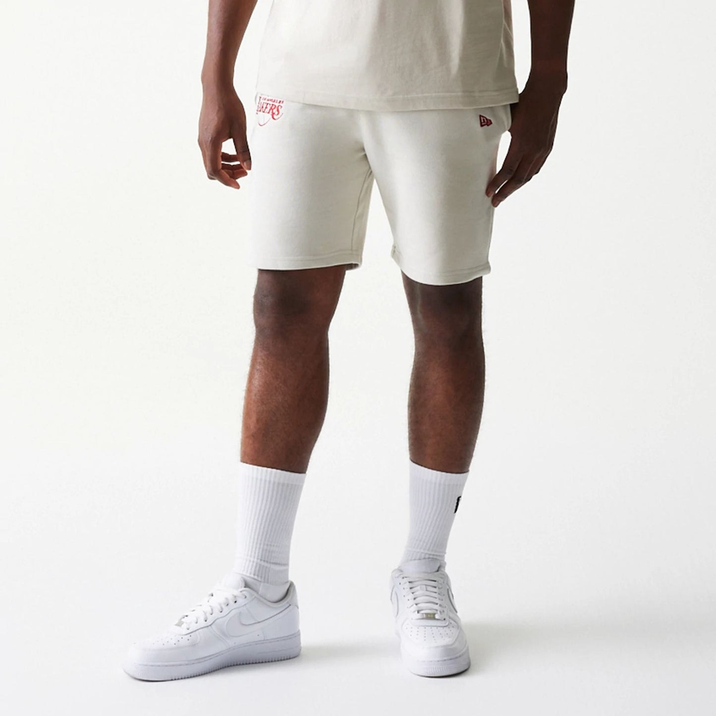 The model is wearing this NBA League Essential LA Lakers Shorts in cream. 8