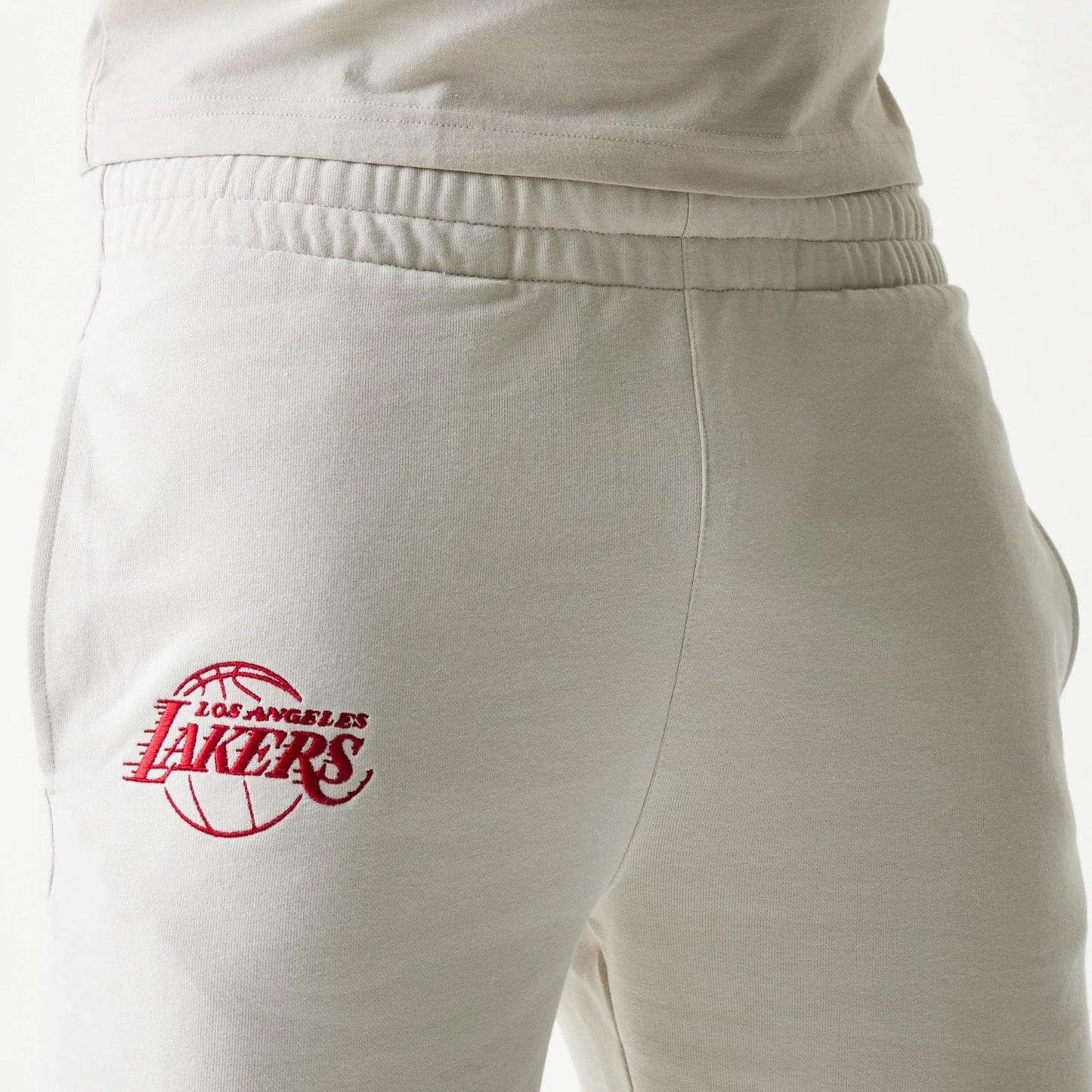 The model is wearing this NBA League Essential LA Lakers Shorts in cream. 5