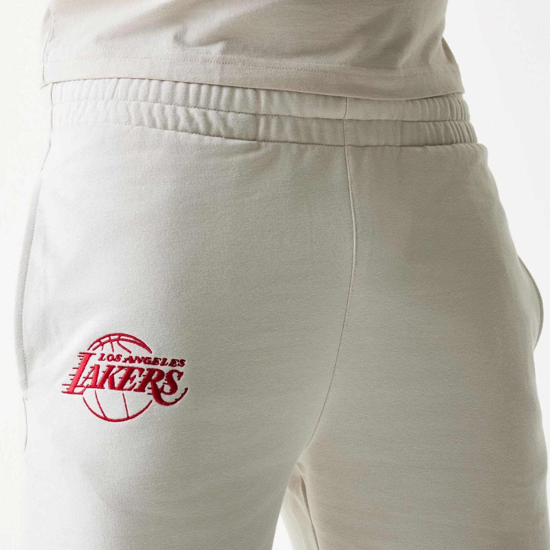 The model is wearing this NBA League Essential LA Lakers Shorts in cream. 5