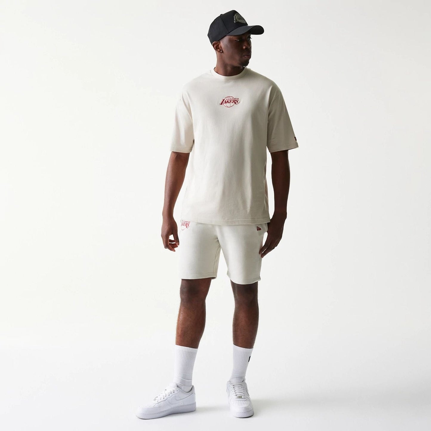 The model is wearing this NBA League Essential LA Lakers Shorts in cream. 7