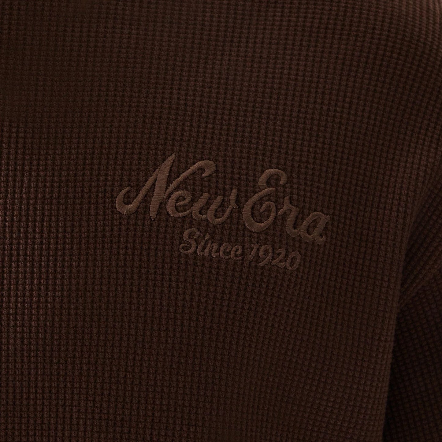 The model is wearing this New Era Script Waffle Crew Neck Sweater in brown. 6