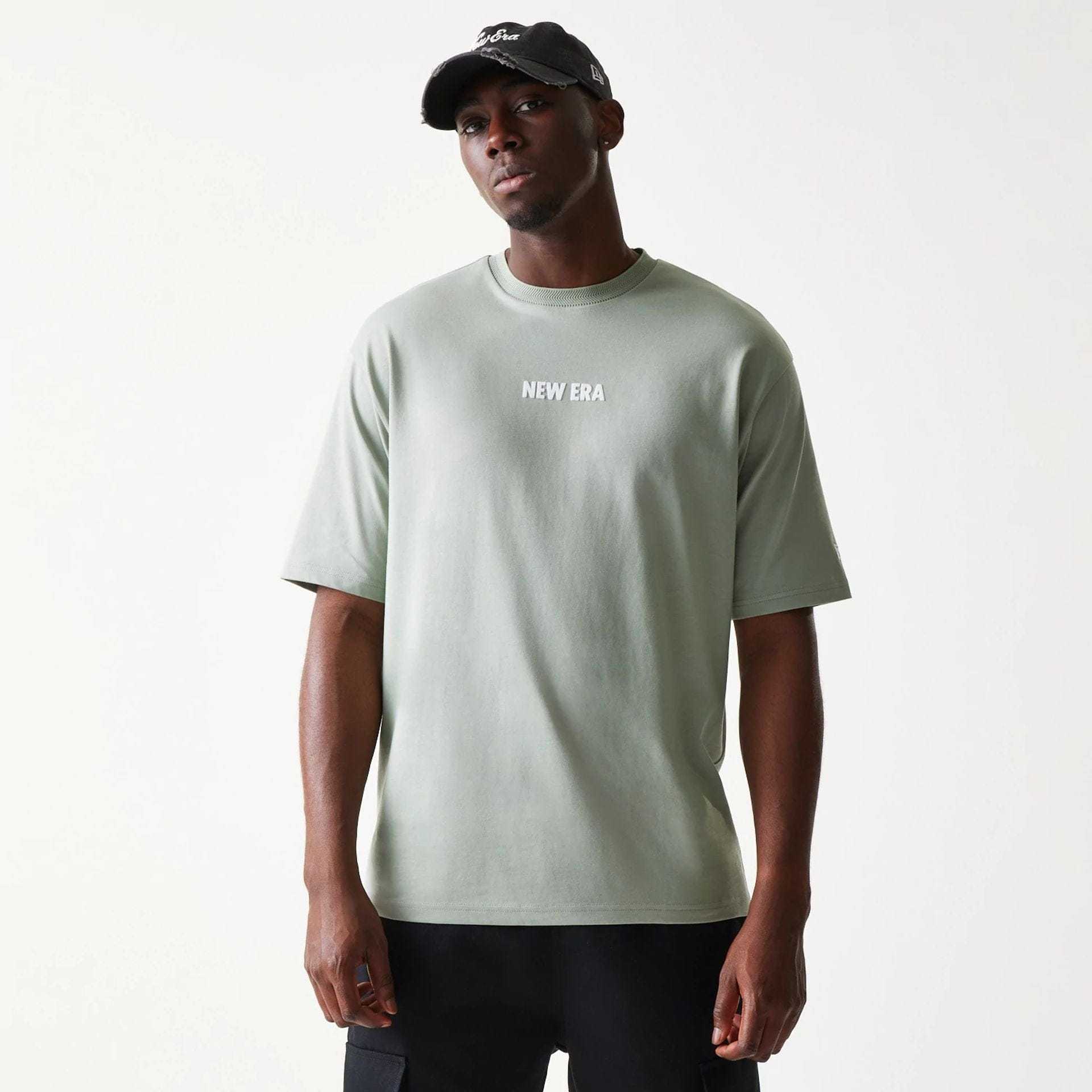 The model is wearing this New Era Graphic Oversized T-Shirt in pastel green. 3