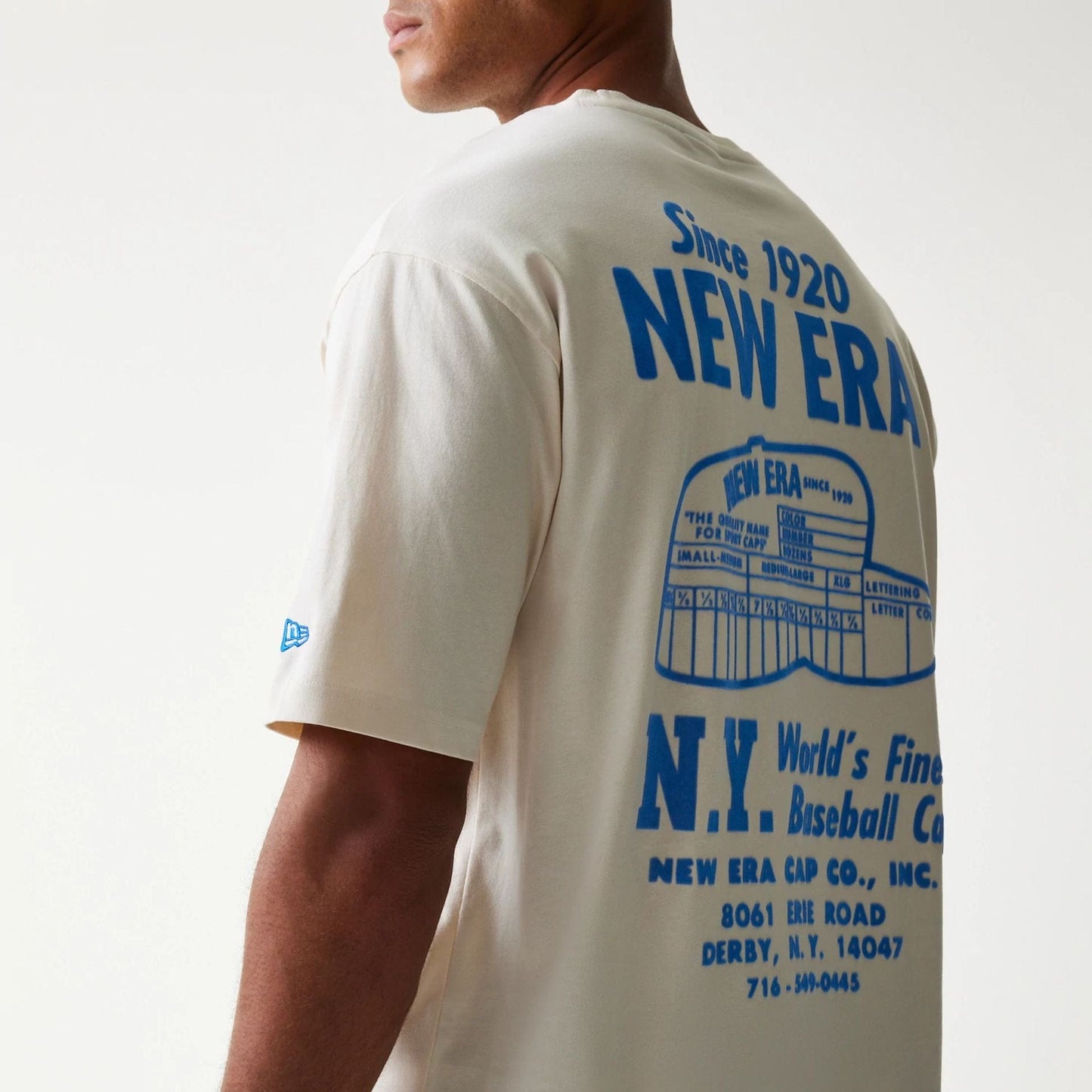 The model is wearing this New Era Graphic Oversized T-Shirt in light beige. 8