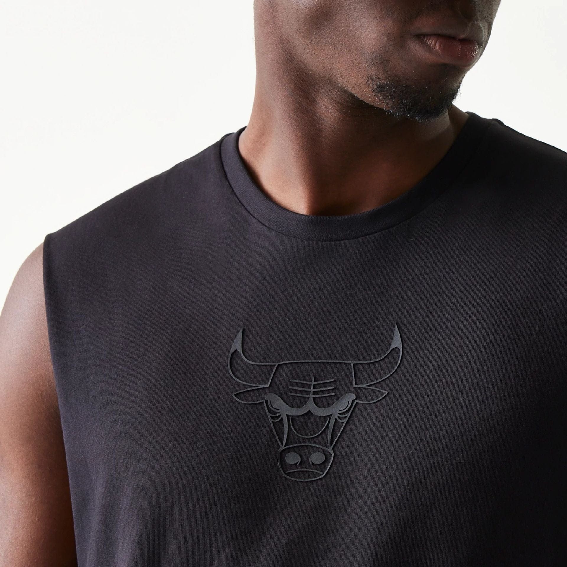The model is wearing this NBA Chicago Bulls Sleeveless T-Shirt in black. 4
