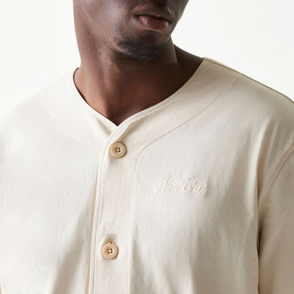 The model is wearing this New Era Script T-Shirt in light beige. 6