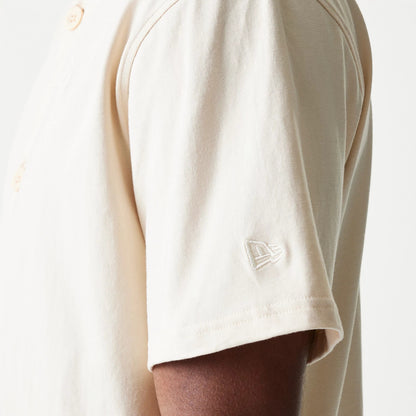 The model is wearing this New Era Script T-Shirt in light beige. 7