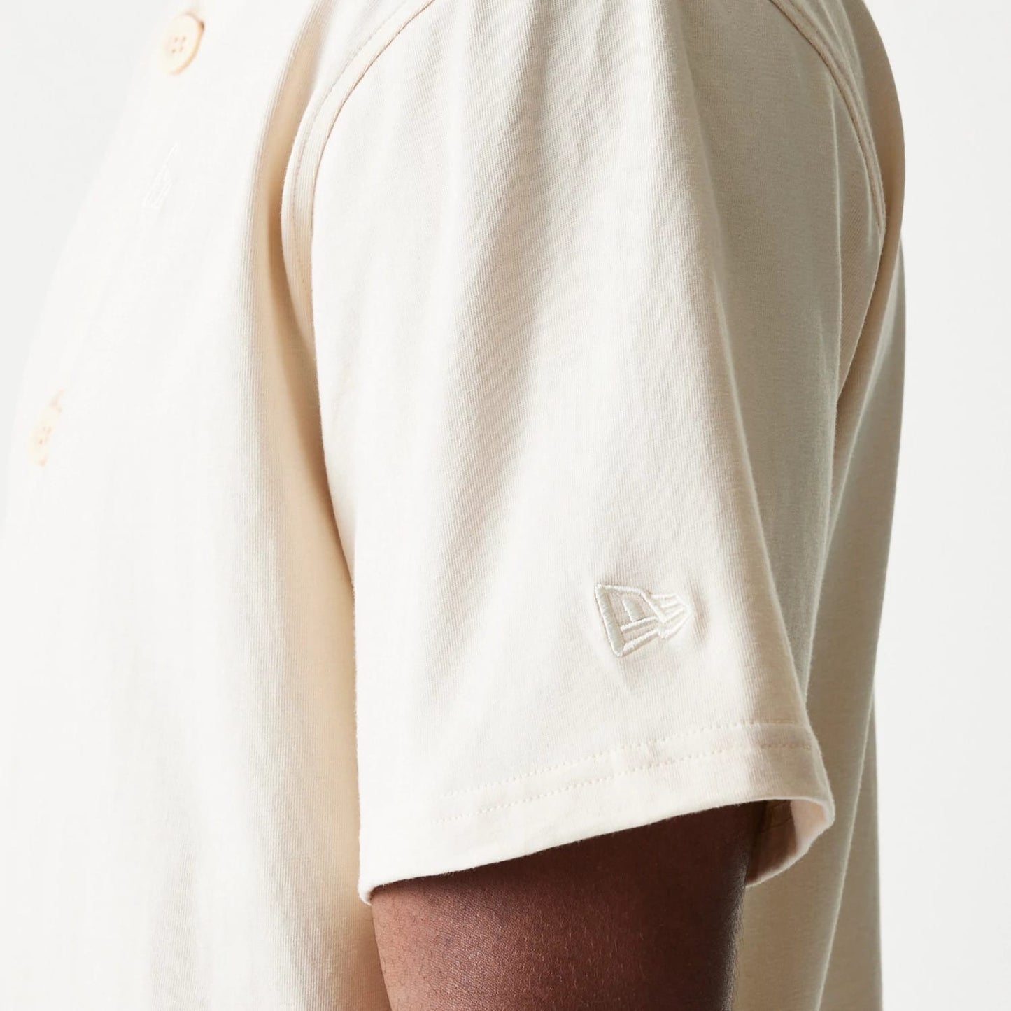 The model is wearing this New Era Script T-Shirt in light beige. 7