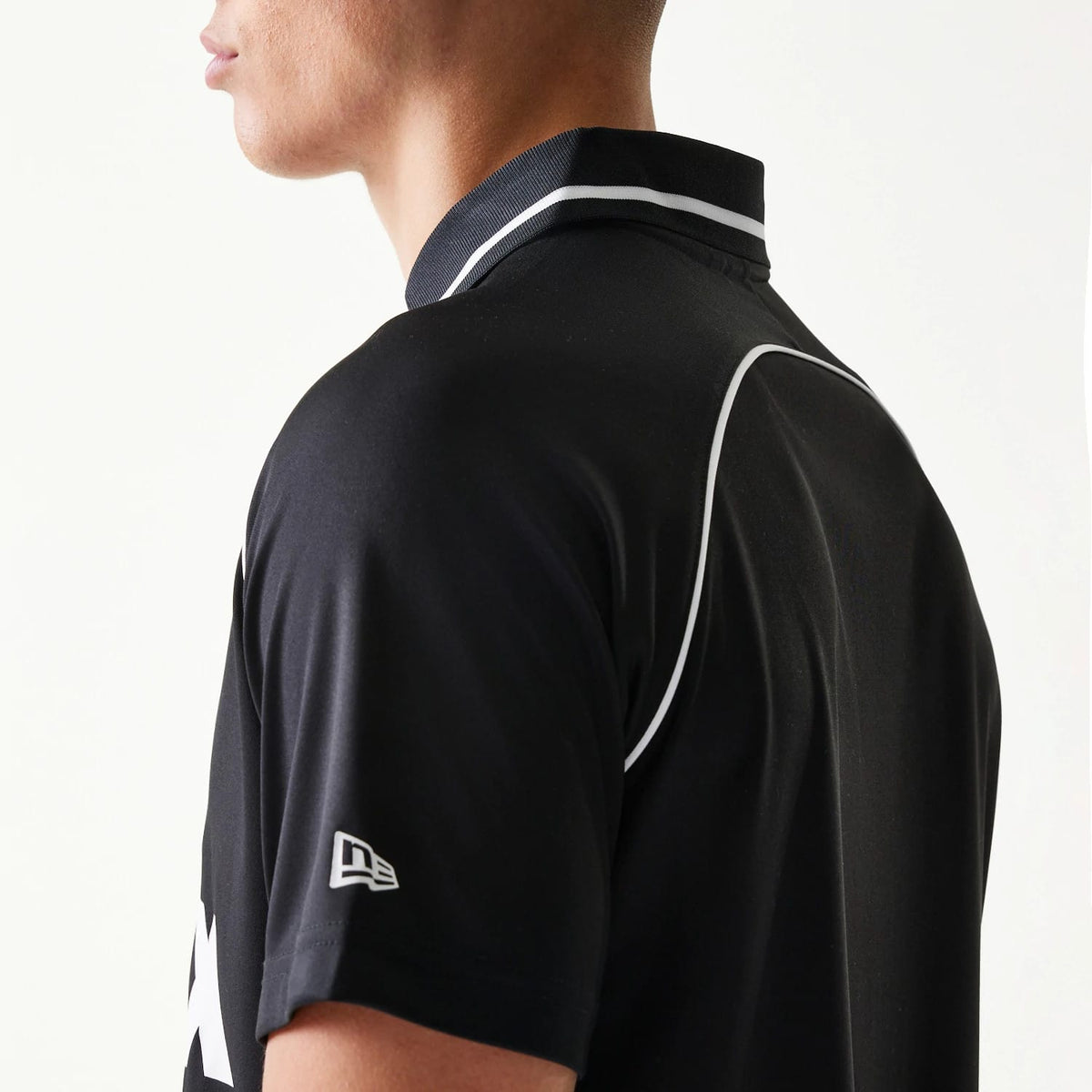 The model is wearing this New Era Football T-Shirt in black. 5