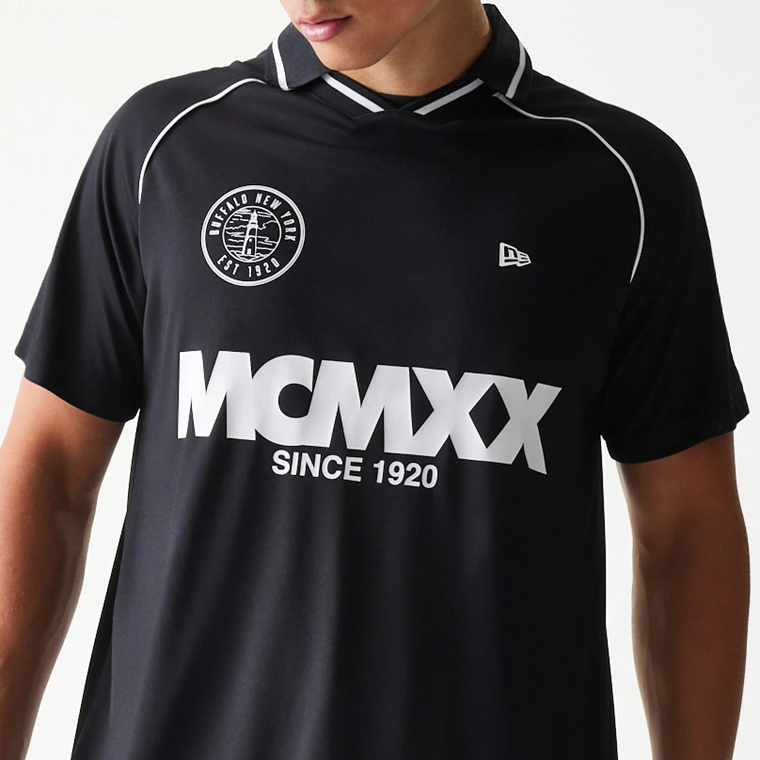 The model is wearing this New Era Football T-Shirt in black. 6