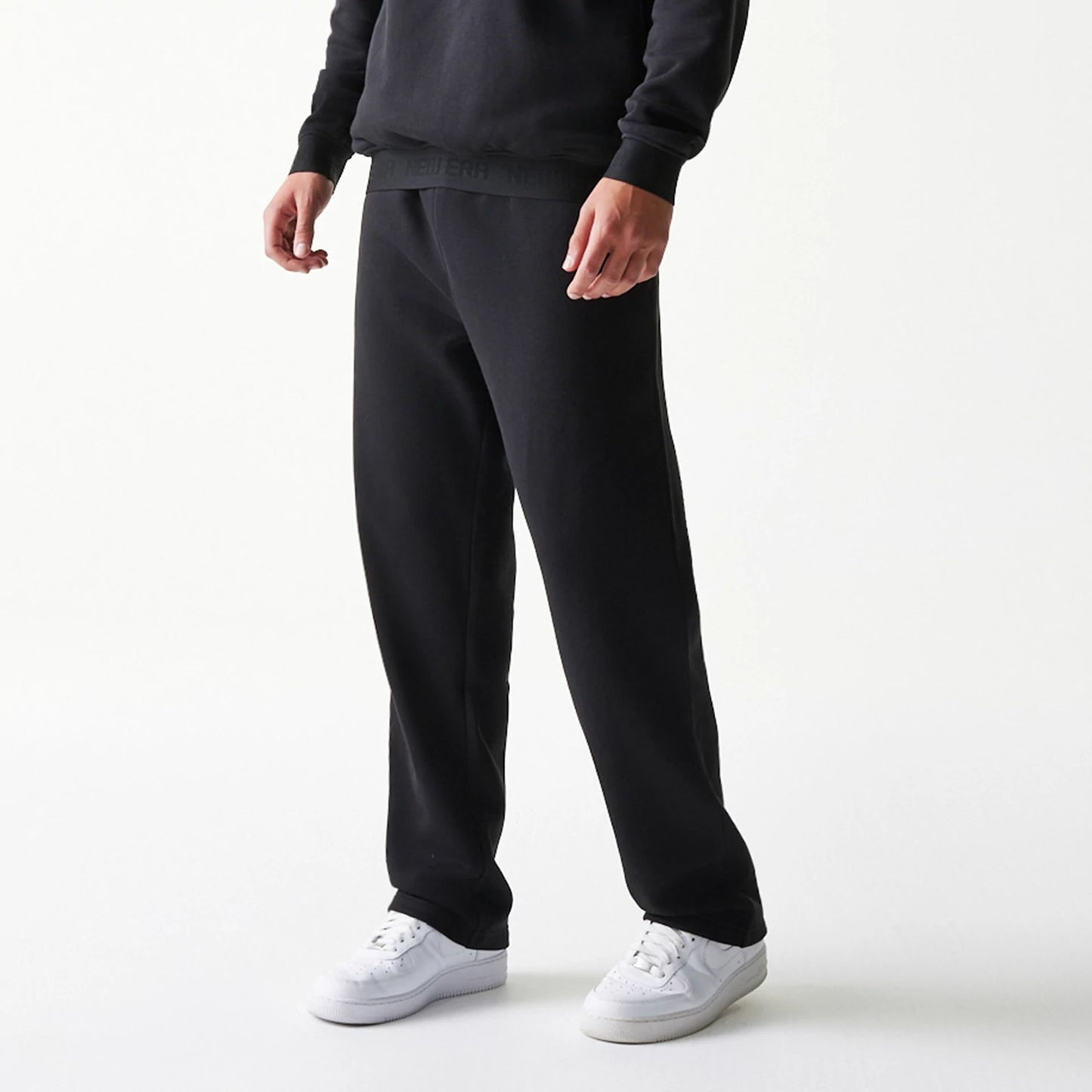 The model is wearing this New Era Tech Straight Leg Joggers in black. 3
