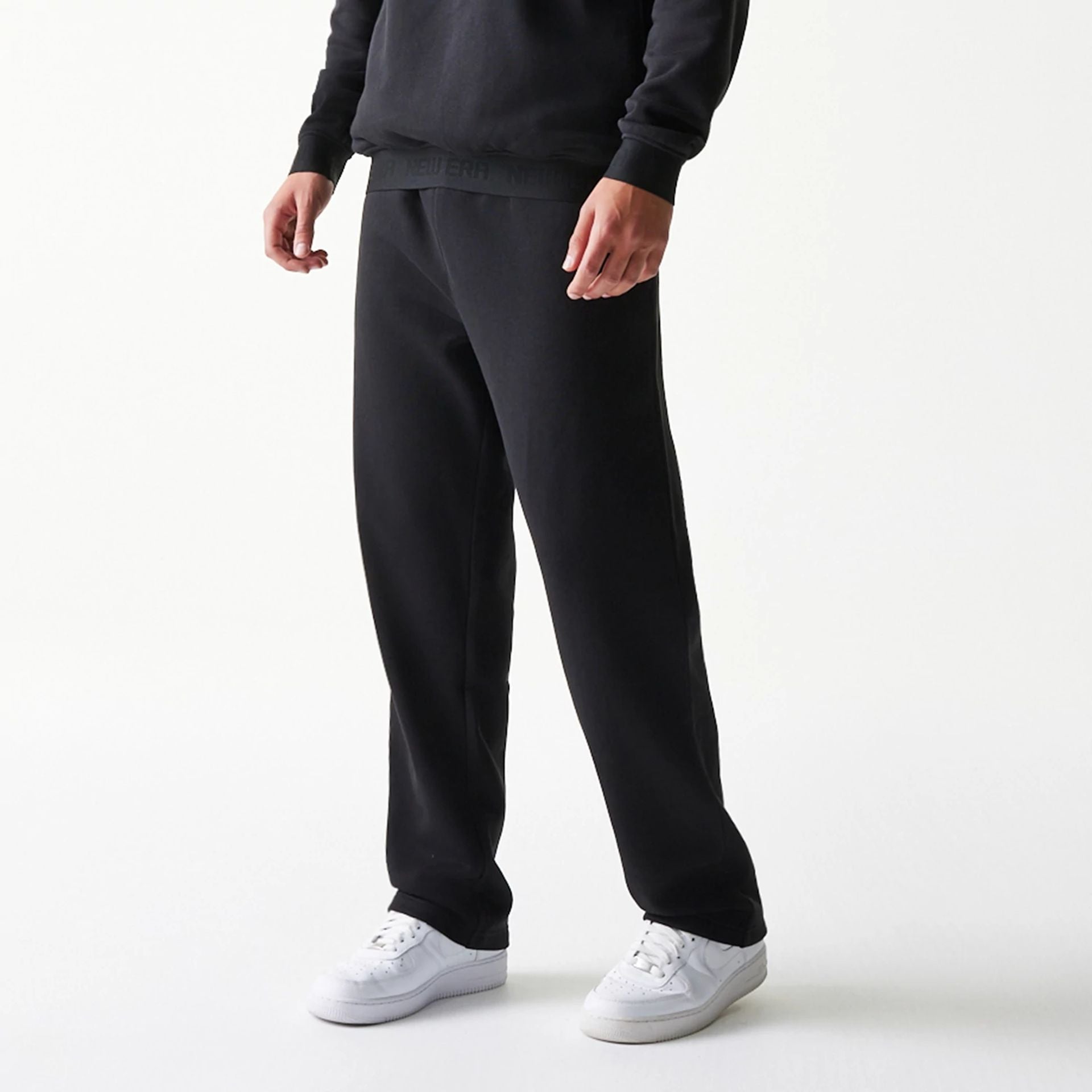 The model is wearing this New Era Tech Straight Leg Joggers in black. 3