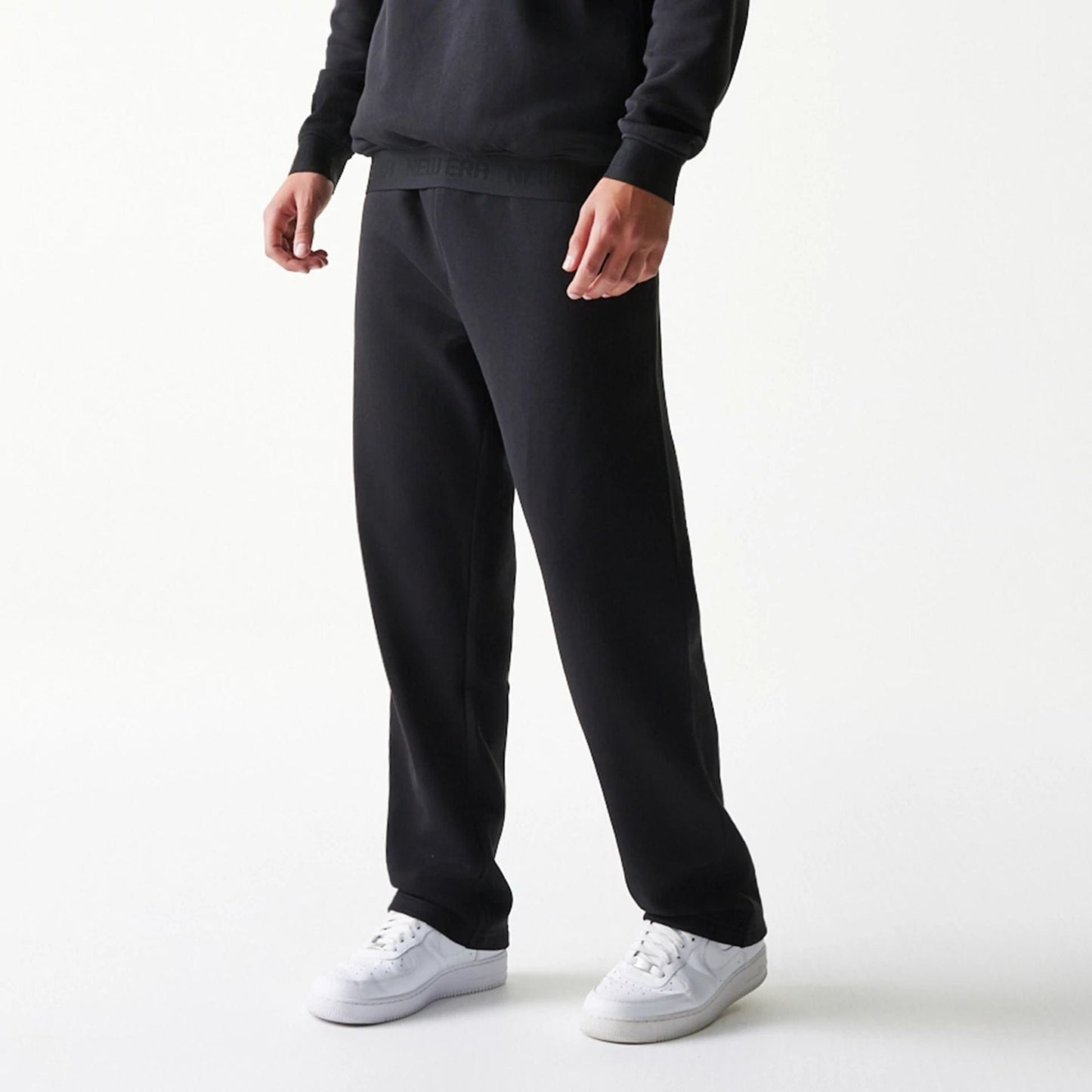 The model is wearing this New Era Tech Straight Leg Joggers in black. 3